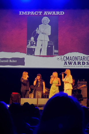Michelle Wright Stacey Lee Guse, Patricia Conroy and Beverley Mahood serenade Carroll as she was awarded the Impact Award, CMAO June 2022. If you are too young perhaps to know Carroll and her accomplishments please look her up. You will then know why she so deservedly won this Impact Award.